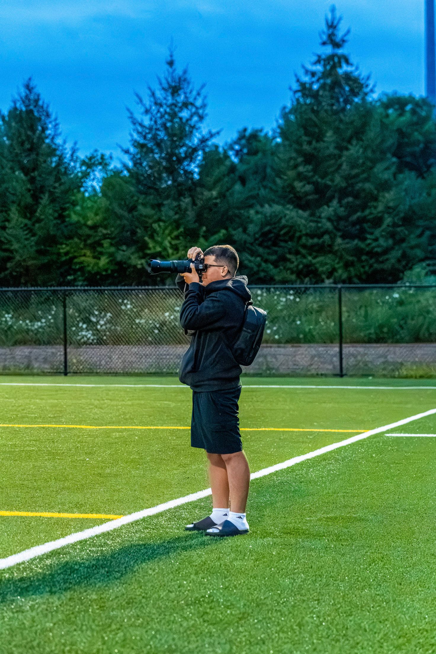 Lucas holding a camera outdoors